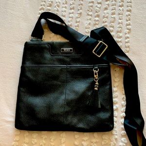 TUMI , Black Leather Crossbody , 2 outside packets, Nylon Strap, Like New.